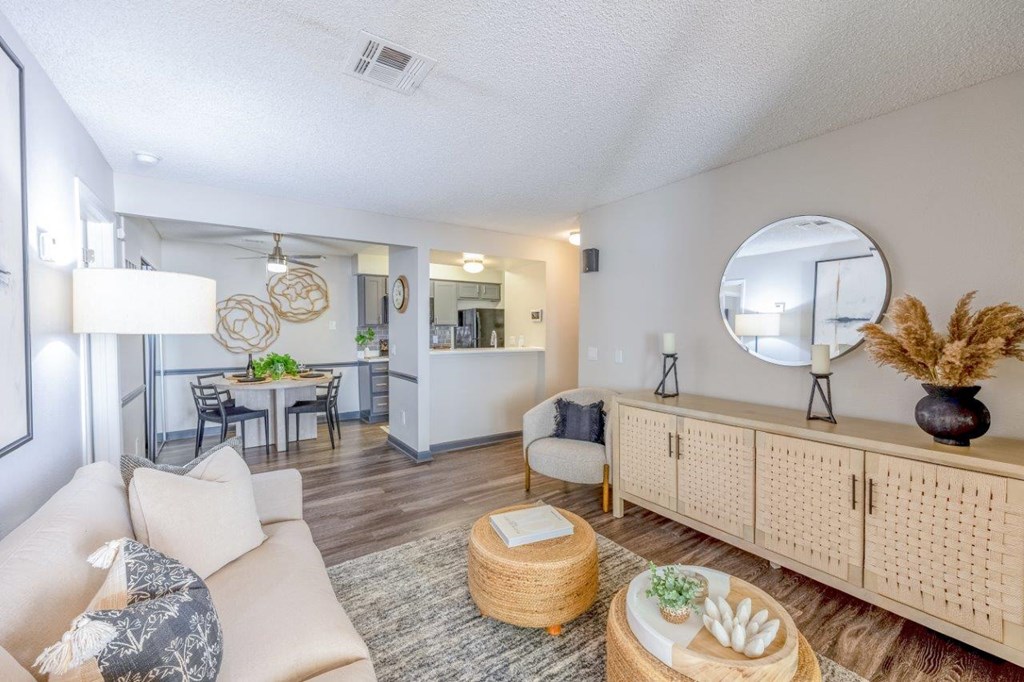 a living room with couches and chairs and a table