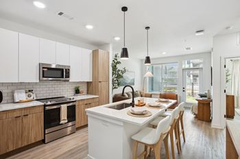 an open kitchen and dining area with a table and chairs