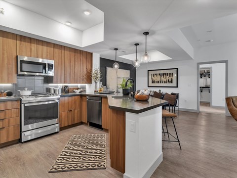 A modern kitchen with wooden cabinets and stainless steel appliances.