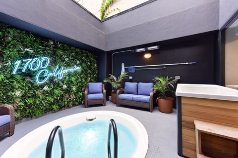 A modern indoor space with a pool and a green wall.