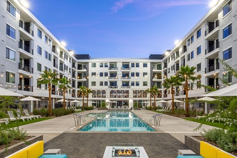 A large white building with a pool in the middle of it.
