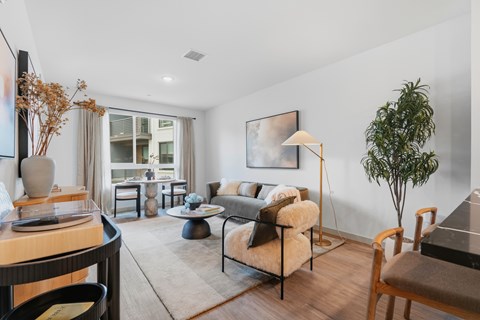 A living room with a brown chair and a brown couch.