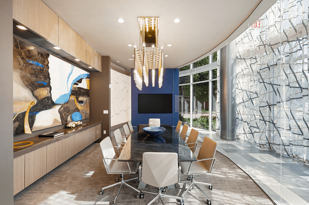 A conference room with a long table and chairs.