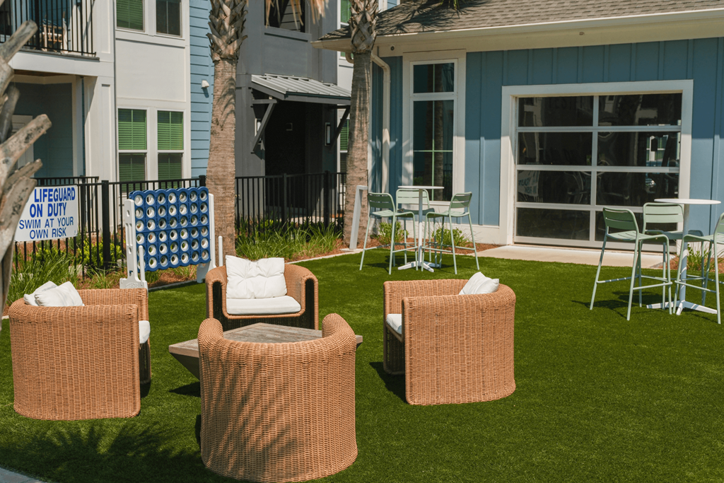 A sign in the background of a lawn reads "LIFEGUARD ON DUTY SWIM AT YOUR OWN RISK".