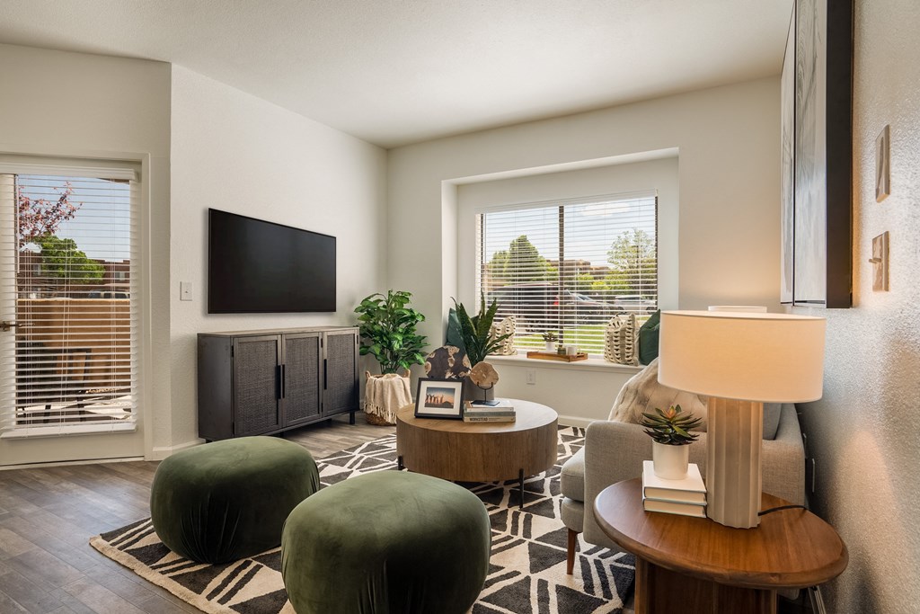 a living room with green chairs and a television