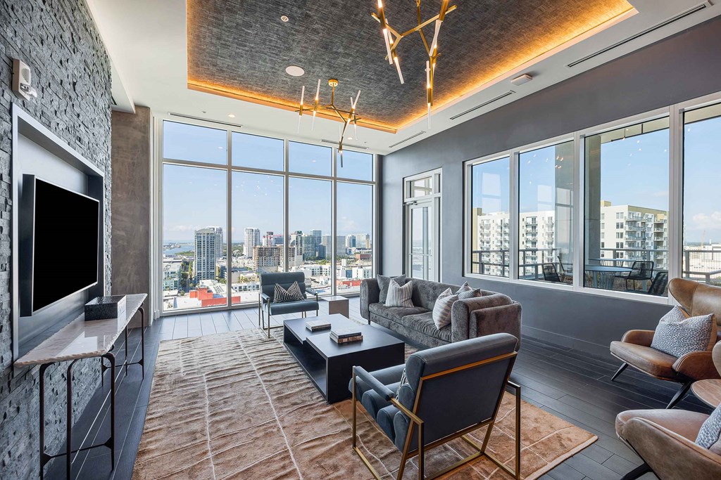 a living room with a view of the city and a tv