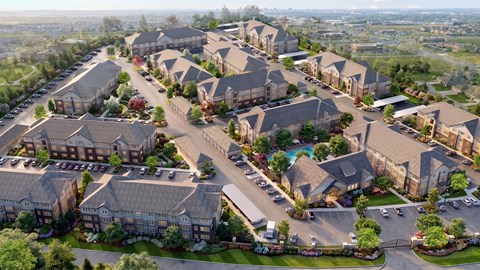 A bird's eye view of a residential complex with multiple buildings and a swimming pool.
