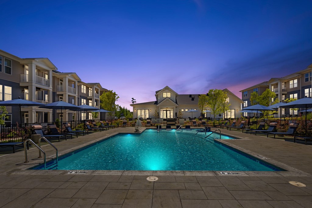 A swimming pool in a residential area surrounded by apartment buildings.