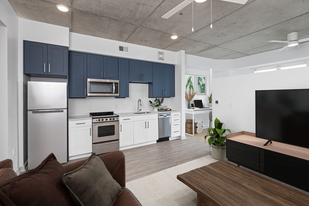 a living room with a couch and a table in front of a tv