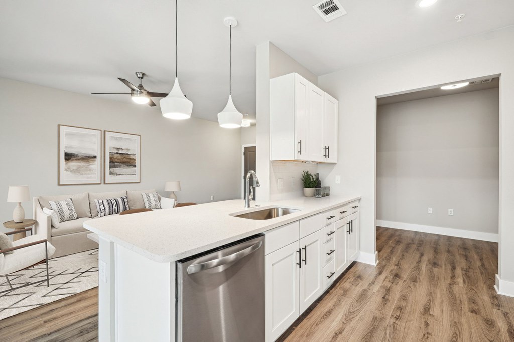 A2  A modern kitchen with white cabinets and a wooden floor.