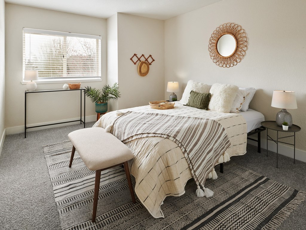 a bedroom with a bed and a window