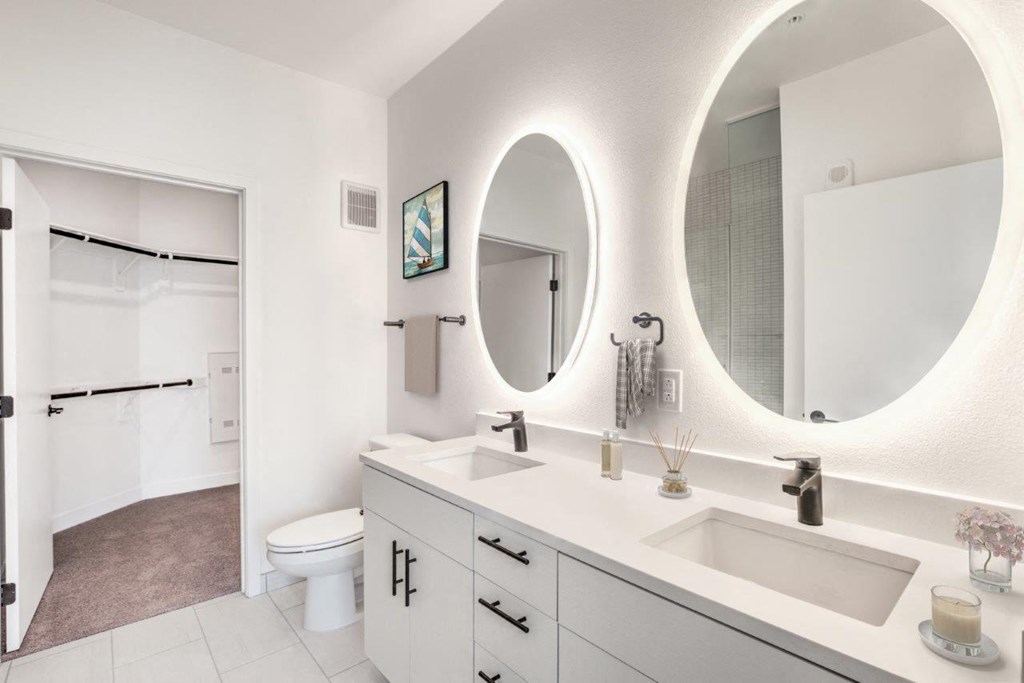 a bathroom with two sinks and a toilet