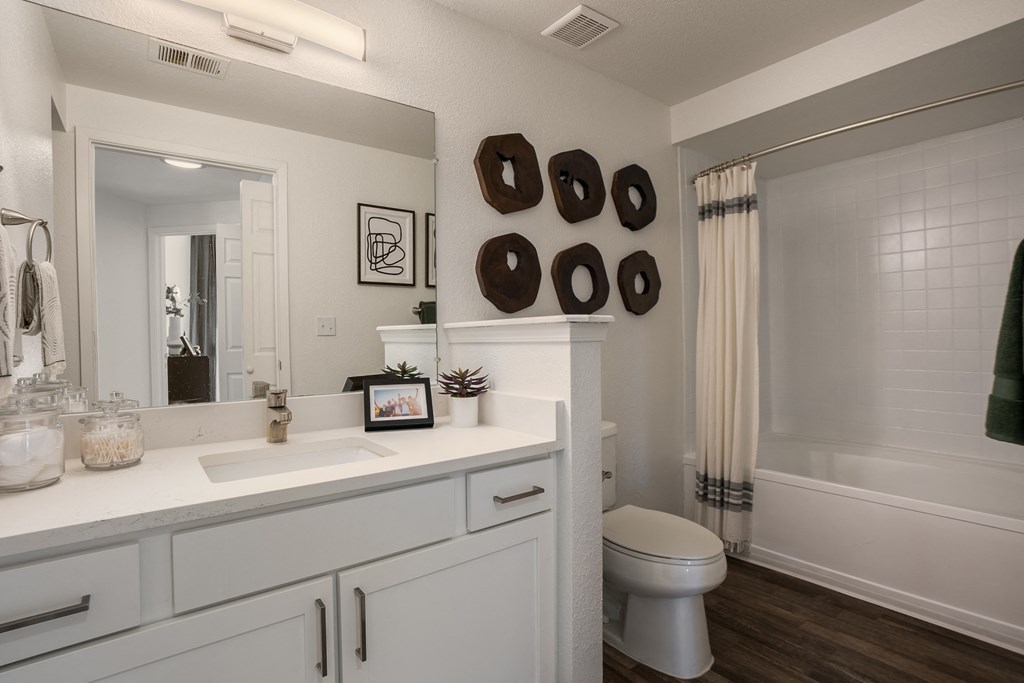 a bathroom with a large mirror and a toilet and a shower