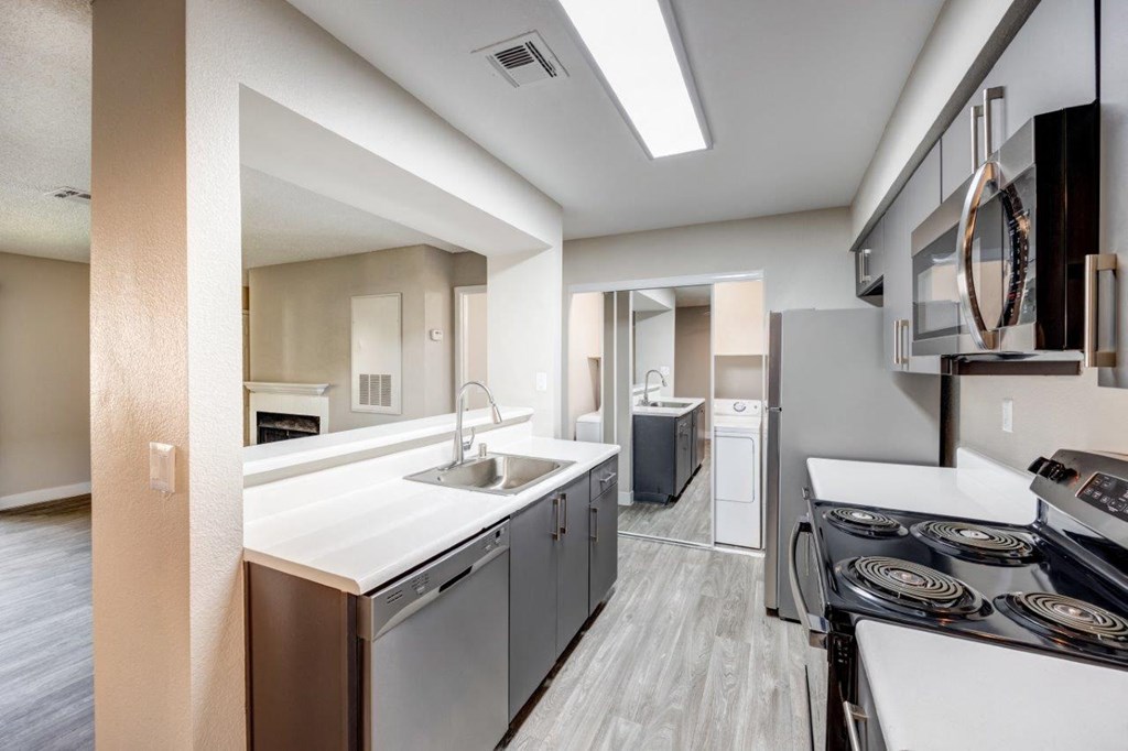 a kitchen with stainless steel appliances and a white counter top