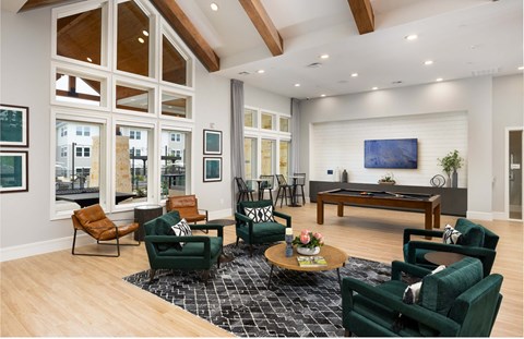 a living room with furniture and a pool table