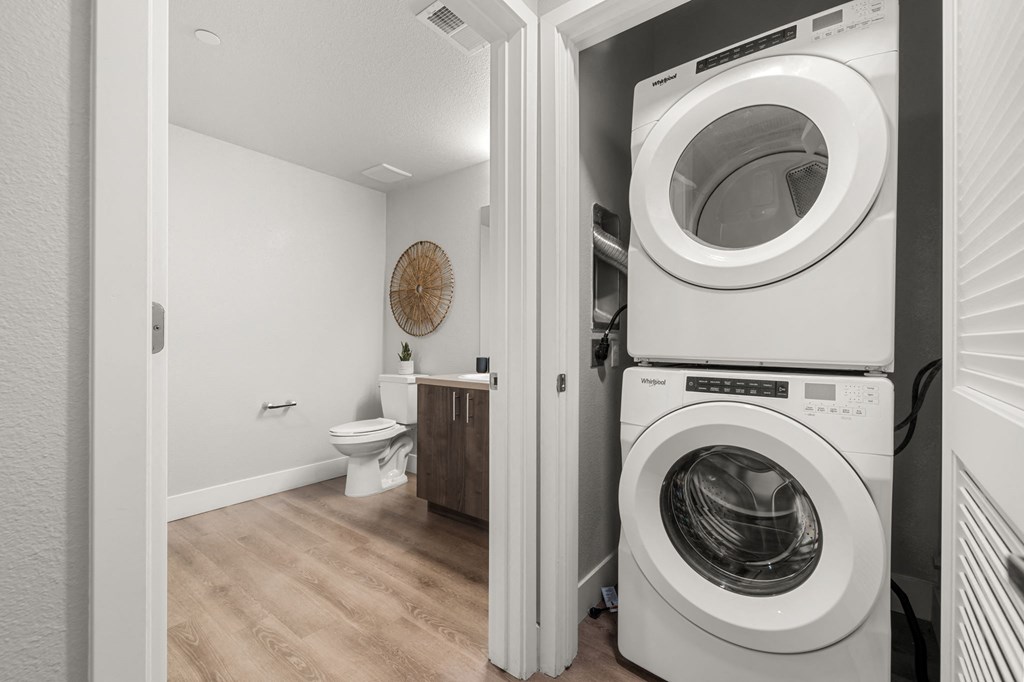 a bathroom with a washer and dryer combo in a 555 waverly unit