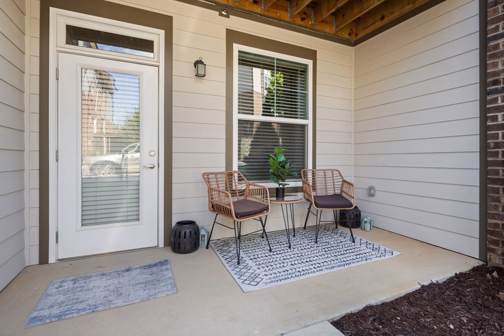 A patio with a table and chairs.