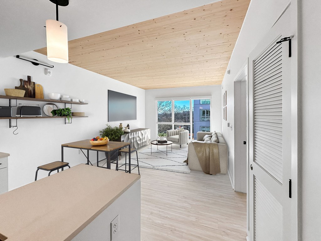 a kitchen with a white counter top and a living room