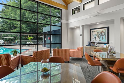 A modern dining room with a glass table and chairs.