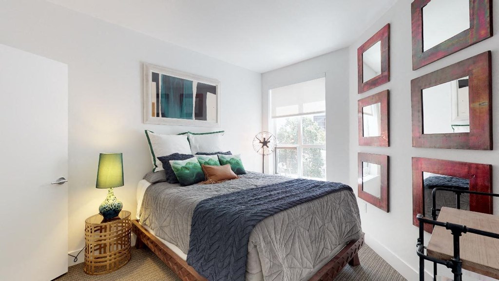 a bedroom with a bed and a large window