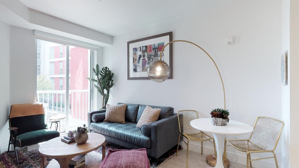 a living room with white walls and a blue couch