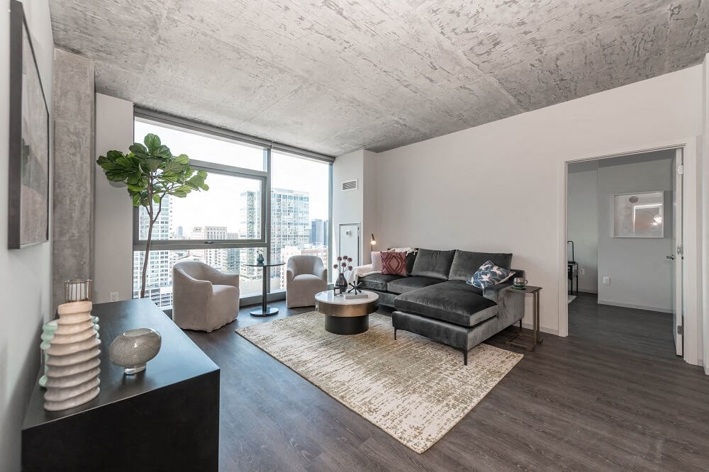 a living room with a leather couch and a large window