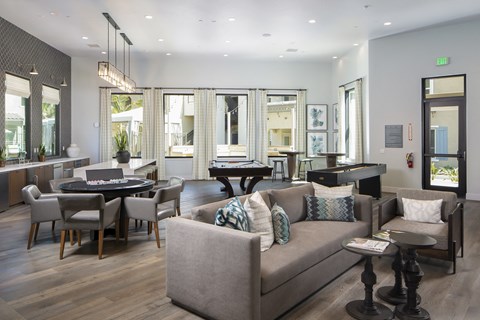 A living room with a grey couch and a black table.