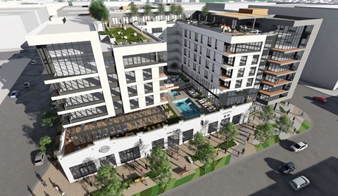 an aerial view of a city street with buildings and trees