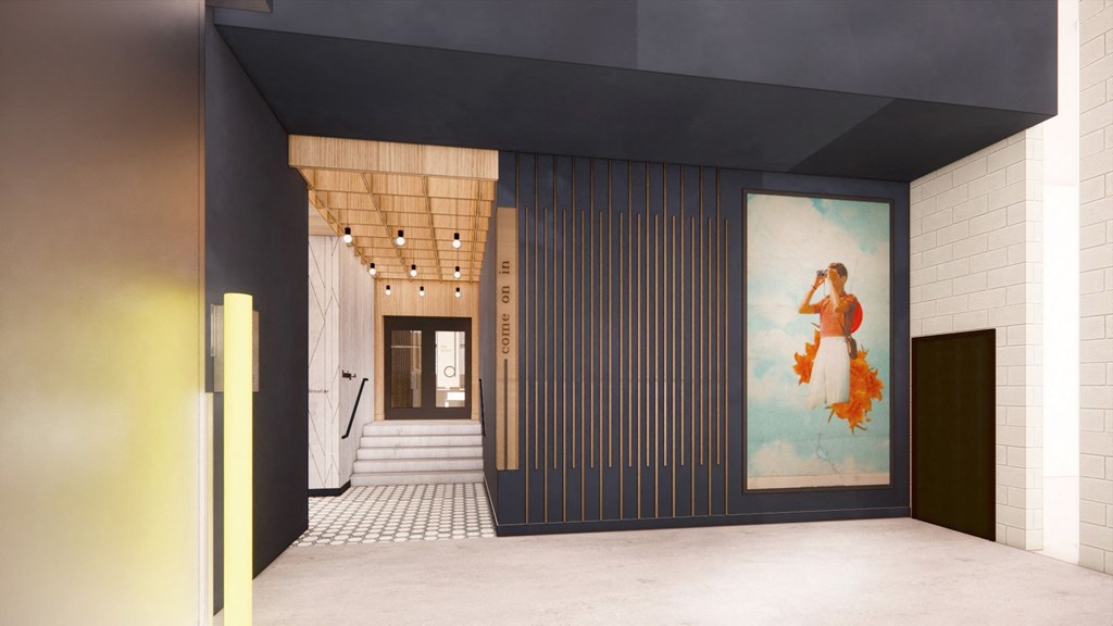 the lobby of a building with black walls and a painting on the wall