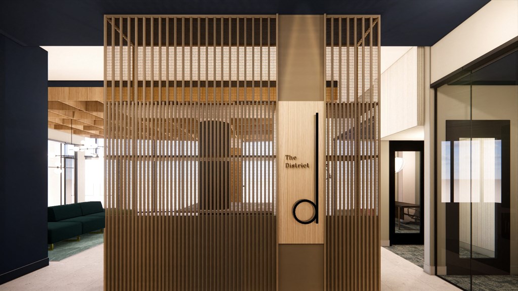 the lobby of a hotel with a large wood divider