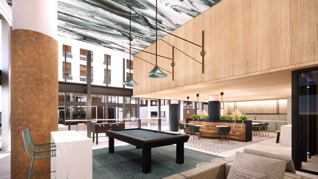 the lobby of a building with a pool table and chairs