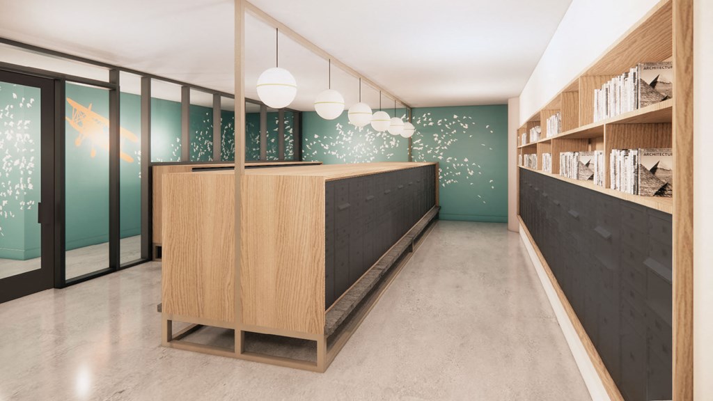a lobby with a wooden reception desk and a green wall