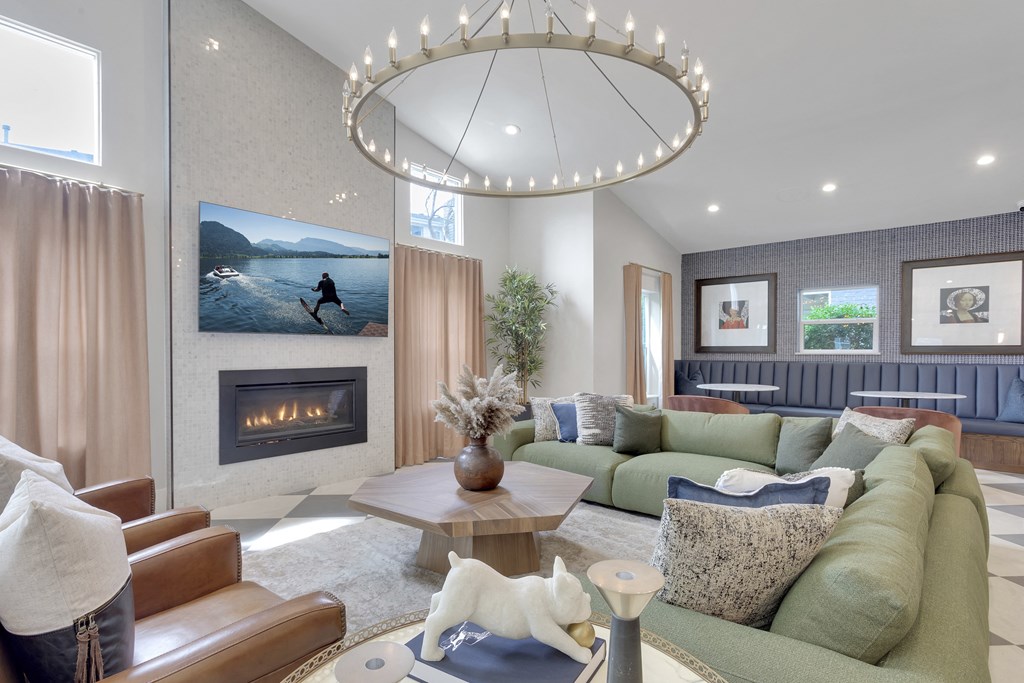 A modern living room with a fireplace and a large painting of a person running on the wall.