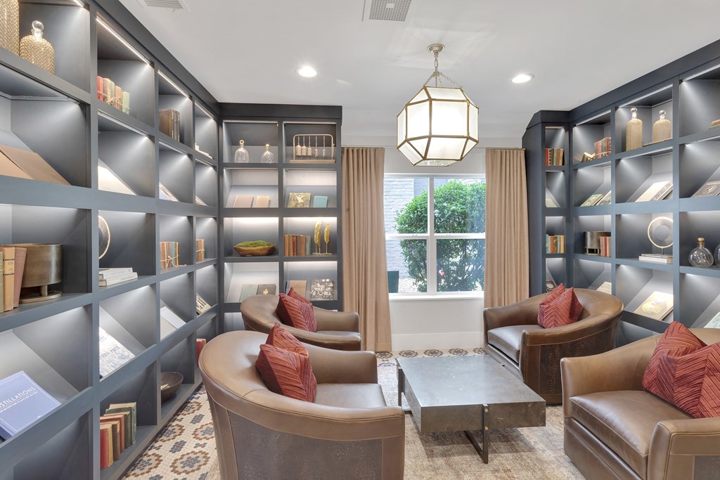 A well-lit, modern living room with a large window and a cozy seating area.