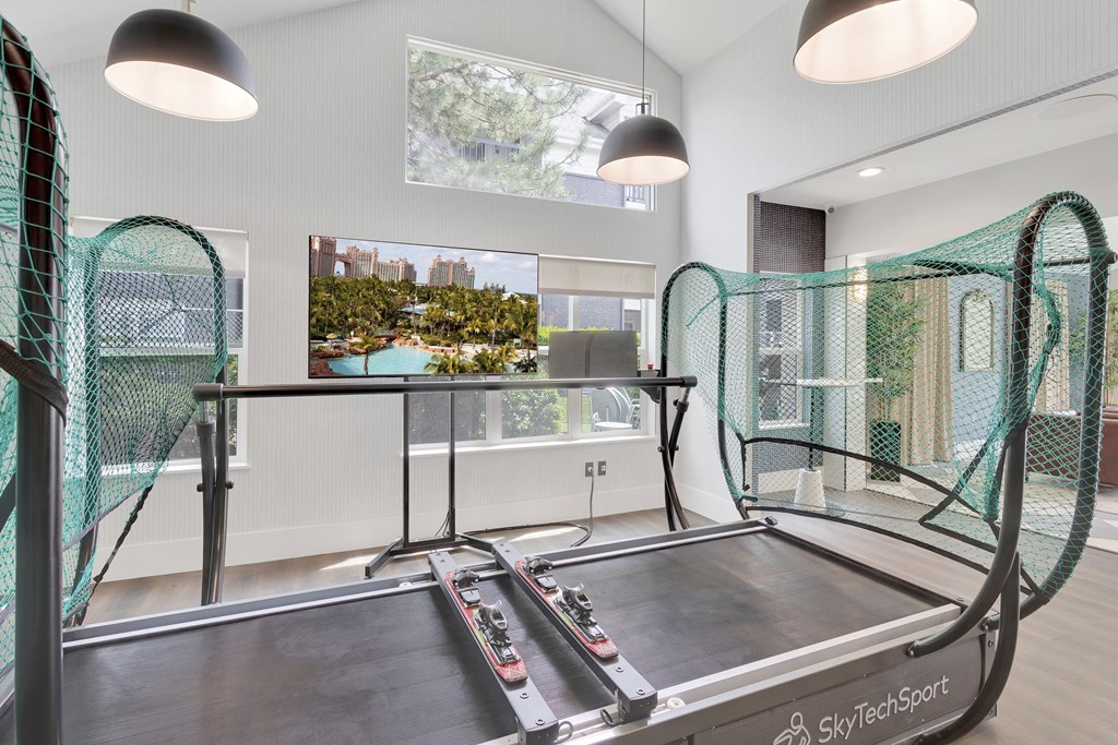 A trampoline room with a large window and a view of a cityscape.