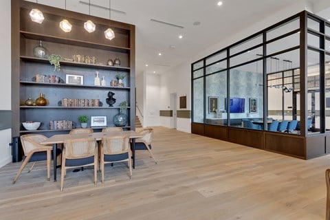 A modern dining room with a wooden table and chairs.