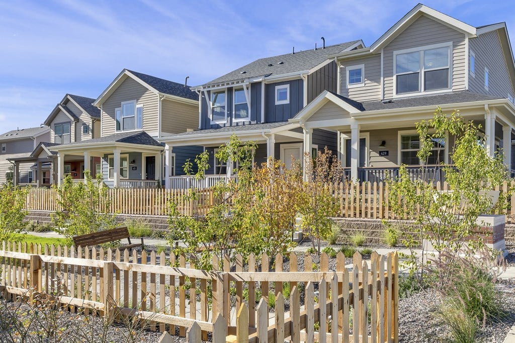 a row of houses with a wooden fence