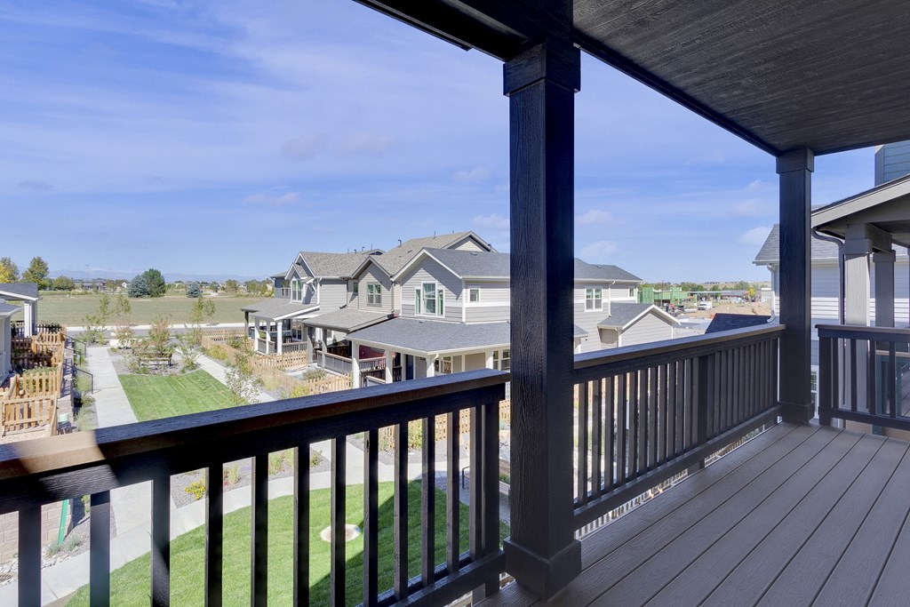 the view from the deck of a home with a yard and houses