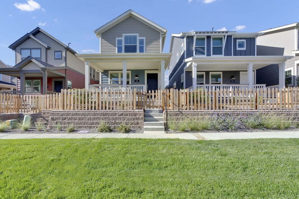 a row of houses with a sidewalk in front of them