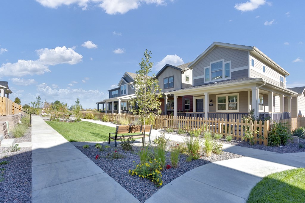 a house with a yard and a sidewalk in front of it