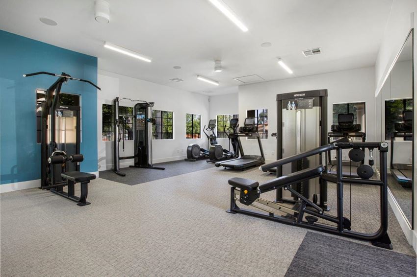 Gym a gym with weights and other equipment in a building