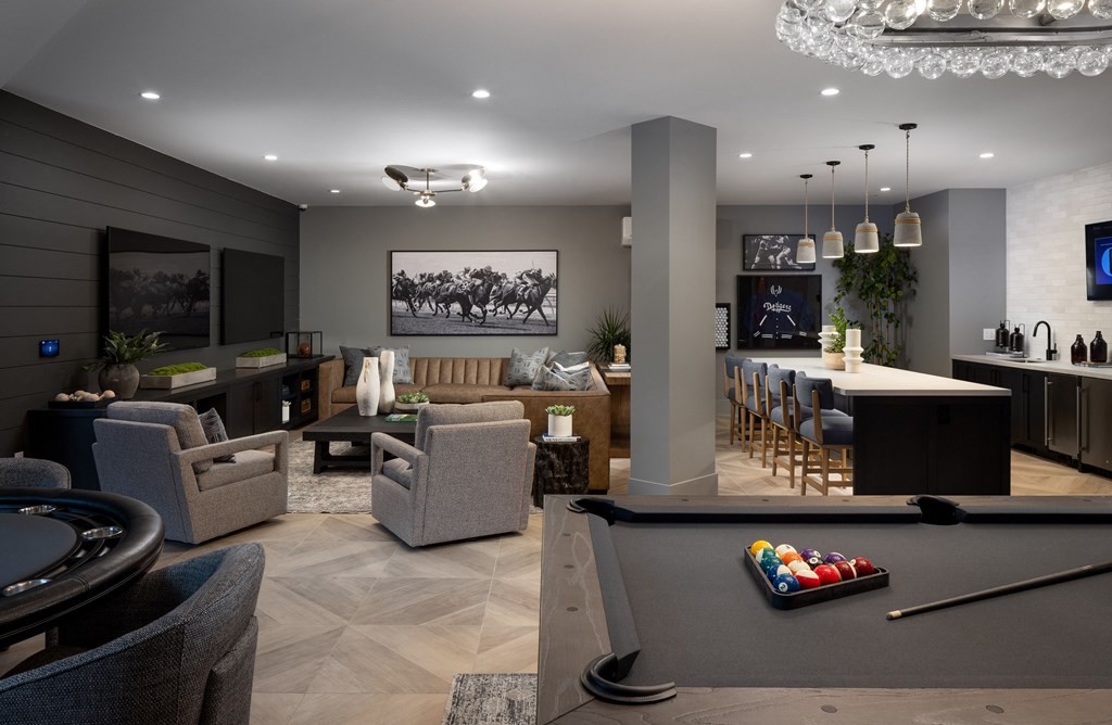 a living room with a pool table and a bar