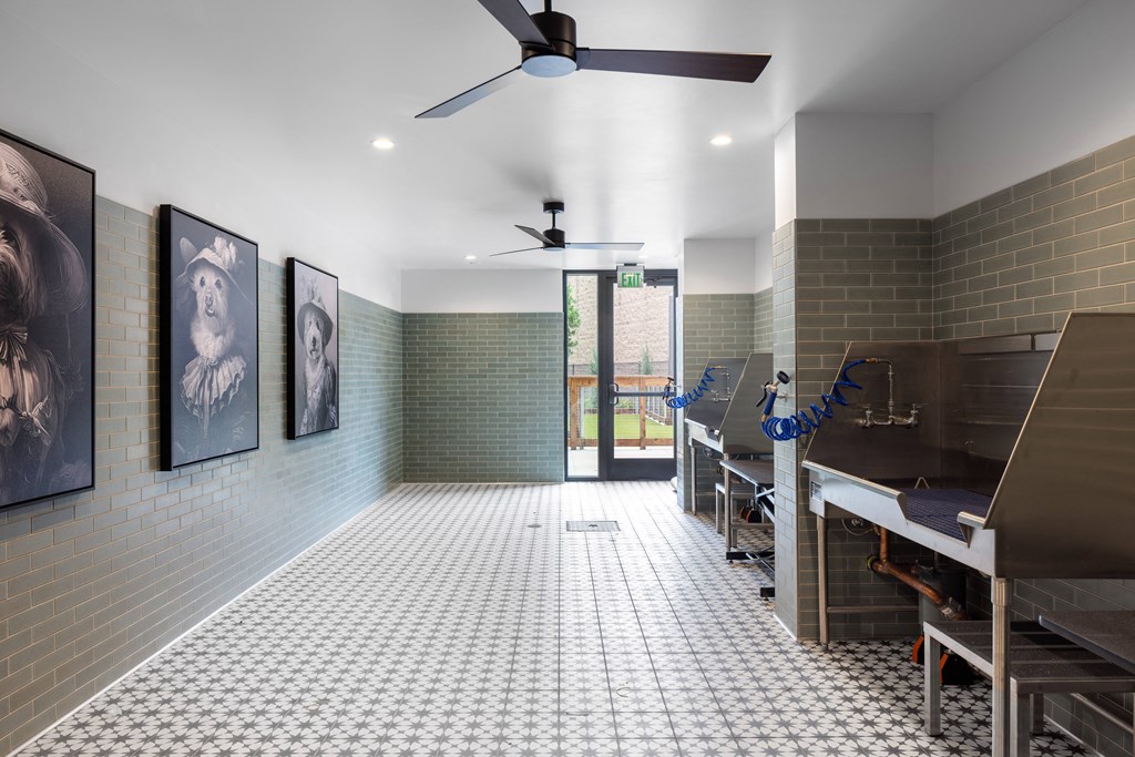 a large room with a piano and a ceiling fan