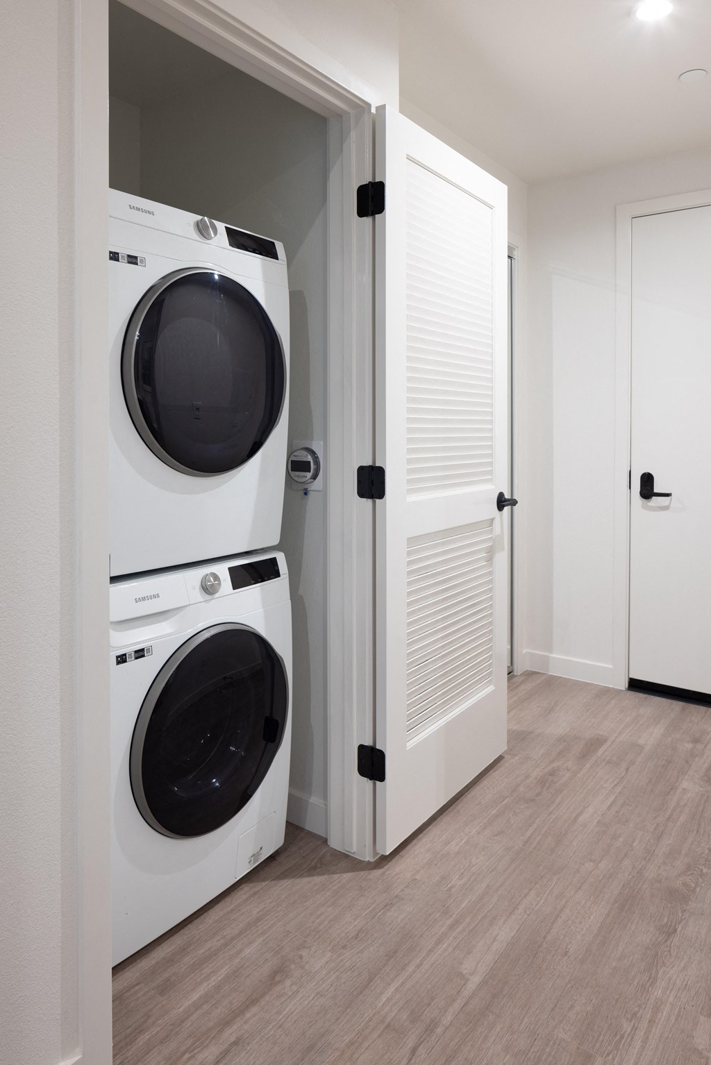 a front loading washer and dryer in a laundry room