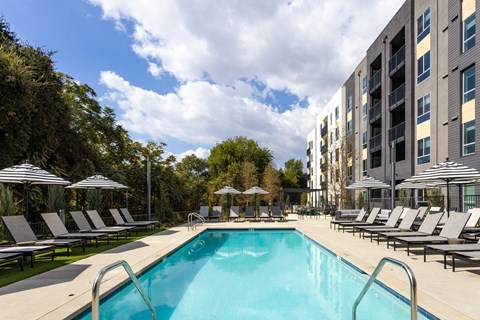 a swimming pool in front of an apartment building