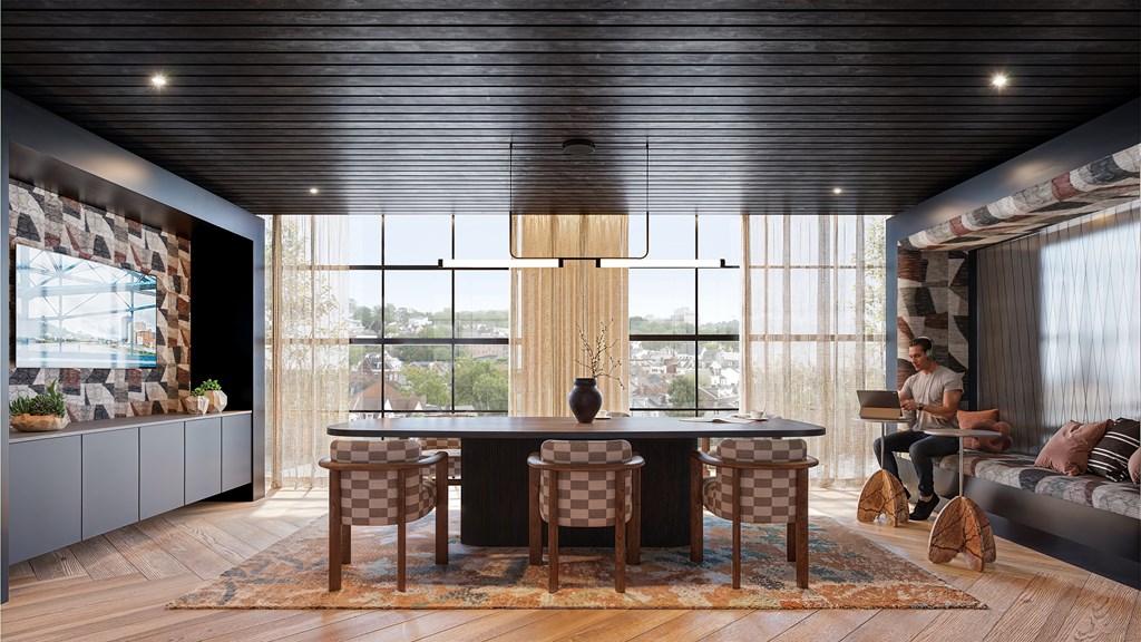 A modern dining room with a large table and chairs.