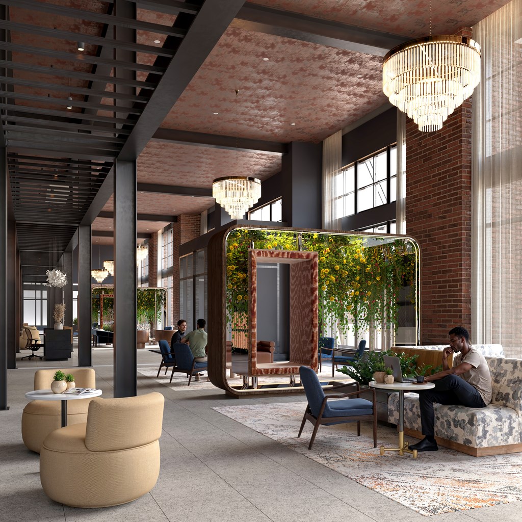 A modern interior with a man sitting on a couch.