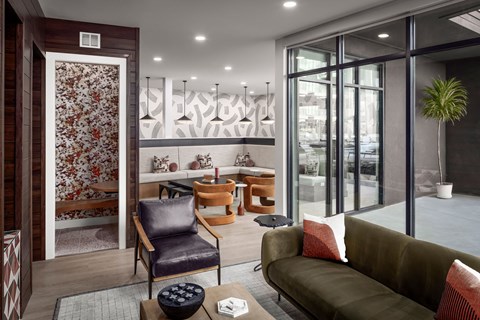 A living room with a green couch, a chair, and a coffee table.