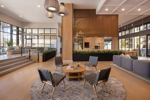 A modern living room with a wooden table and chairs.