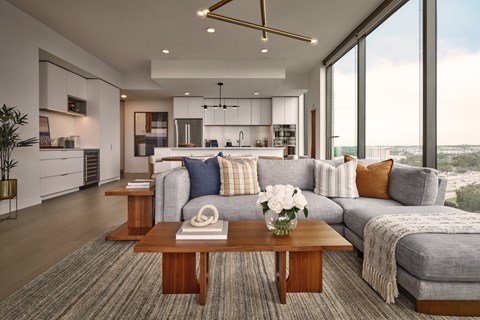 A modern living room with a grey sofa and a coffee table.